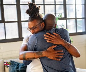 2 men hugging after talking about their problems together and supporting each other.