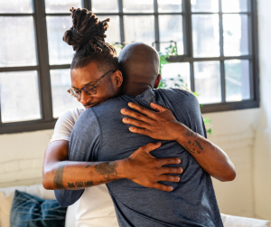 Two people embracing, representing compassionate support for veterans in the UK
